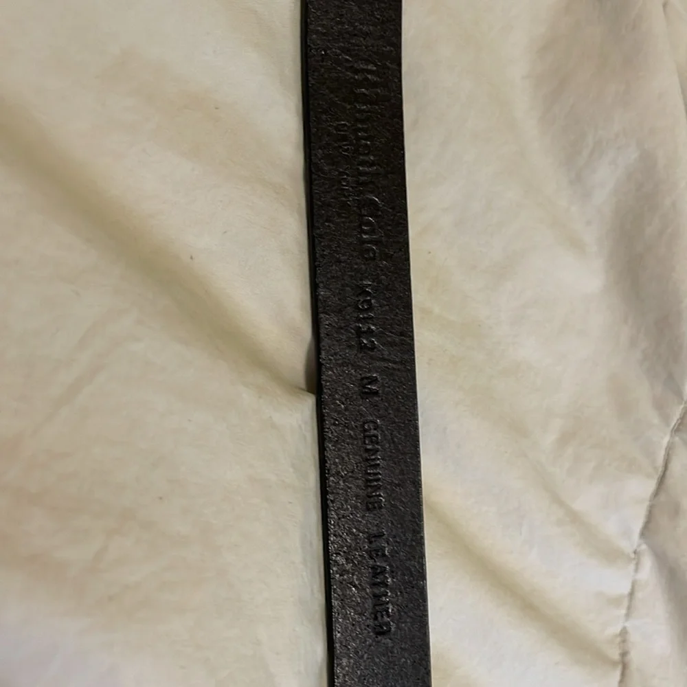 Genuine leather belt from Kenneth Cole. Metal buckle. Measures about 35 inches.